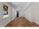 Finished basement with hardwood floors, neutral walls, and access to stairs at 4309 Birmingham Way, Raleigh, NC 27604
