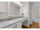 Bathroom with a large granite countertop vanity and stylish white cabinets and gold hardware at 4309 Birmingham Way, Raleigh, NC 27604