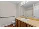 Neutral bathroom featuring a single sink vanity with a light countertop and safety assist bars near the toilet and shower at 4309 Birmingham Way, Raleigh, NC 27604