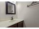 Half bath features a wood vanity with a light colored countertop and a decorative mirror at 4309 Birmingham Way, Raleigh, NC 27604