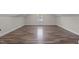 An open bonus room with light brown wood laminate flooring and a dormer window at 4309 Birmingham Way, Raleigh, NC 27604