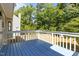 Exterior shot of a blue painted wooden deck overlooking a wooded backyard at 4309 Birmingham Way, Raleigh, NC 27604