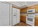 Kitchen featuring oak cabinets and white appliances at 4309 Birmingham Way, Raleigh, NC 27604