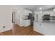 Spacious kitchen with stainless steel refrigerator, white cabinets and granite countertops at 4309 Birmingham Way, Raleigh, NC 27604