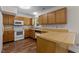 Kitchen featuring oak cabinetry, a wooden countertop and a white stove at 4309 Birmingham Way, Raleigh, NC 27604