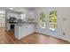 Bright kitchen featuring white cabinets, granite countertops, and a door leading to the outside deck at 4309 Birmingham Way, Raleigh, NC 27604