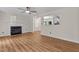 Spacious living room featuring a fireplace, ceiling fan, and open floor plan at 4309 Birmingham Way, Raleigh, NC 27604
