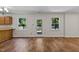 Living room featuring wood floors, access to the backyard and two windows for natural light at 4309 Birmingham Way, Raleigh, NC 27604
