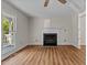 Bright living room with wood flooring, a fireplace and large window at 4309 Birmingham Way, Raleigh, NC 27604