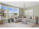 Inviting living room featuring a large sectional sofa, neutral color palette and large windows at 48 Honeydew Way, Clayton, NC 27520