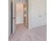 Bright bedroom with plush carpeting, a large closet, and a glimpse into the hallway offers comfort and storage at 5017 Shipper Ln, Durham, NC 27703