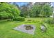 Landscaped backyard featuring a decorative pond and a park bench at 502 Hiddenbrook Dr, Durham, NC 27703