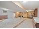 Unfinished basement with stairs, shelving, water heater, and plumbing at 502 Hiddenbrook Dr, Durham, NC 27703