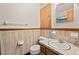 Bathroom with marble-style vanity, wood paneling, and mirror cabinet at 502 Hiddenbrook Dr, Durham, NC 27703