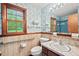 Vintage bathroom features marble countertop, blue tile shower, and window at 502 Hiddenbrook Dr, Durham, NC 27703