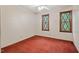 Carpeted bedroom featuring diamond-patterned windows and a ceiling fan at 502 Hiddenbrook Dr, Durham, NC 27703