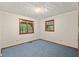Bright bedroom features large windows, plush carpeting, and neutral walls at 502 Hiddenbrook Dr, Durham, NC 27703