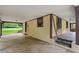 Carport featuring tiled steps leading to a stucco home at 502 Hiddenbrook Dr, Durham, NC 27703