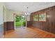 Dining room features hardwood floors, wood paneling, classic chandelier and sliding glass doors at 502 Hiddenbrook Dr, Durham, NC 27703
