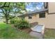Side view showcasing the home's exterior with lush landscaping and access to basement at 502 Hiddenbrook Dr, Durham, NC 27703