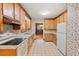 Retro kitchen features wood cabinets, marble countertops, and vintage appliances at 502 Hiddenbrook Dr, Durham, NC 27703