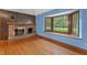 Inviting living room showcasing hardwood floors, a brick fireplace, and a sunlit bay window at 502 Hiddenbrook Dr, Durham, NC 27703