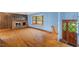 Spacious living room boasts hardwood floors, brick fireplace, and bright bay window at 502 Hiddenbrook Dr, Durham, NC 27703