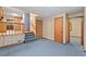 Spacious living room with adjacent kitchen, access to laundry, and natural light at 502 Hiddenbrook Dr, Durham, NC 27703