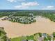 Aerial view of the neighborhood featuring a lake, mature trees, and single Gathering homes at 510 N Waters Edge Dr, Durham, NC 27703