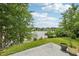 Backyard patio offers a view of the lake surrounded by trees and lush green grass at 510 N Waters Edge Dr, Durham, NC 27703