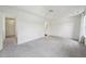Empty bedroom featuring neutral carpet, ceiling fan, and large windows at 510 N Waters Edge Dr, Durham, NC 27703