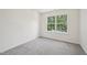 Bedroom features neutral colors, carpeted floor, large window offering natural light, and electrical outlets at 510 N Waters Edge Dr, Durham, NC 27703
