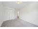 Neutral bedroom with carpet, large closet doors, and a door leading out to hallway at 510 N Waters Edge Dr, Durham, NC 27703