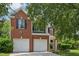 Charming two-story brick home features a two-car garage and manicured landscaping at 510 N Waters Edge Dr, Durham, NC 27703