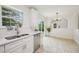 Well-appointed kitchen with stainless steel dishwasher, white cabinets, and an adjacent dining area at 510 N Waters Edge Dr, Durham, NC 27703