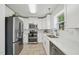 Well-equipped kitchen with stainless steel appliances, white cabinets, and ample counter space at 510 N Waters Edge Dr, Durham, NC 27703