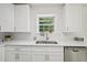 Well-lit kitchen features white cabinets, stainless steel appliances, and a large window at 510 N Waters Edge Dr, Durham, NC 27703