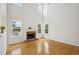 Inviting living room boasts a brick fireplace, large windows, and hardwood flooring at 510 N Waters Edge Dr, Durham, NC 27703
