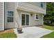 View of the patio featuring neutral siding, a sliding glass door, and lush green grass at 510 N Waters Edge Dr, Durham, NC 27703