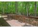 Wood deck surrounded by lush trees, offering privacy and a scenic view at 524 Preston Andrews Rd, Bahama, NC 27503
