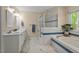Serene bathroom with a soaking tub, separate shower, dual vanities, and marble floors offers a spa-like experience at 524 Preston Andrews Rd, Bahama, NC 27503