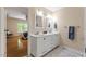 Updated bathroom with marble floors, dual sink vanity, and a doorway to an adjacent bedroom at 524 Preston Andrews Rd, Bahama, NC 27503