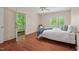 Cozy bedroom with a door to a private porch, natural light, hardwood floors, and comfortable decor at 524 Preston Andrews Rd, Bahama, NC 27503