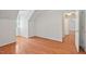Large bedroom featuring hardwood floors, white walls, a ceiling fan and a unique dormer window at 524 Preston Andrews Rd, Bahama, NC 27503