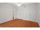 Large bedroom with hardwood floors, white walls, a ceiling fan and double closets at 524 Preston Andrews Rd, Bahama, NC 27503