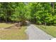 Gravel driveway leading to a home surrounded by lush greenery at 524 Preston Andrews Rd, Bahama, NC 27503