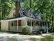 Two story home featuring a screened-in porch, brick chimney and mature trees at 524 Preston Andrews Rd, Bahama, NC 27503
