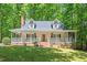Charming traditional-style home featuring a brick chimney and a welcoming front porch at 524 Preston Andrews Rd, Bahama, NC 27503