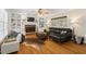 Inviting living room featuring a brick fireplace, built-in bookshelves, and hardwood flooring at 524 Preston Andrews Rd, Bahama, NC 27503
