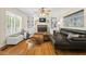 Bright living room with hardwood floors, a brick fireplace, and comfortable seating at 524 Preston Andrews Rd, Bahama, NC 27503